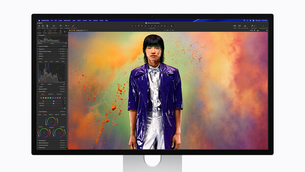 Screenshot of photo editing software with portrait of person in purple jacket against colorful abstract background.