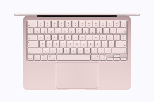 Overhead view of a pink laptop with open display and illuminated keyboard.