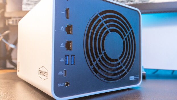 Blue and white desktop computer with large circular cooling fan and multiple USB ports on front panel.