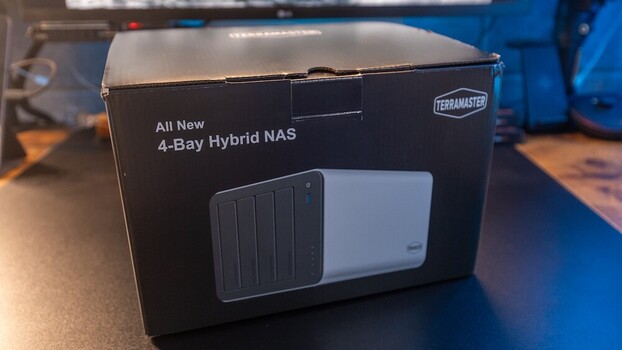 TerraMaster 4-bay hybrid NAS device box showing black and white unit design against blue background.
