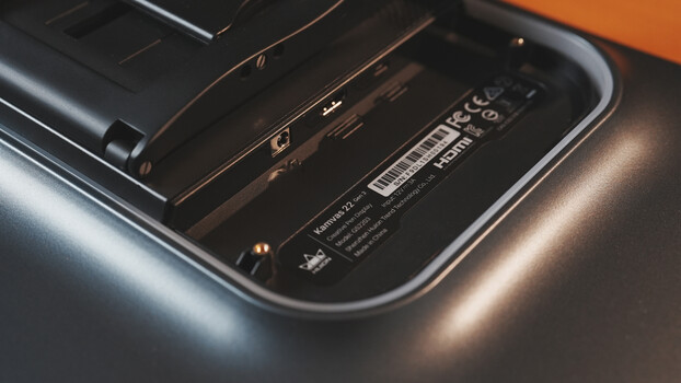 Close-up of camera body showing ports, specifications label, and metallic finishes under studio lighting.