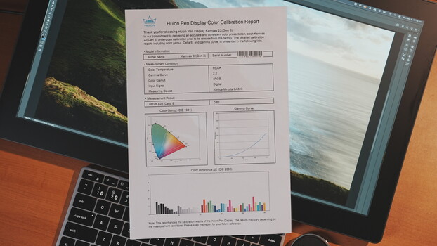 Huon Pen Display Color Calibration Report printed on paper, displayed on laptop screen.