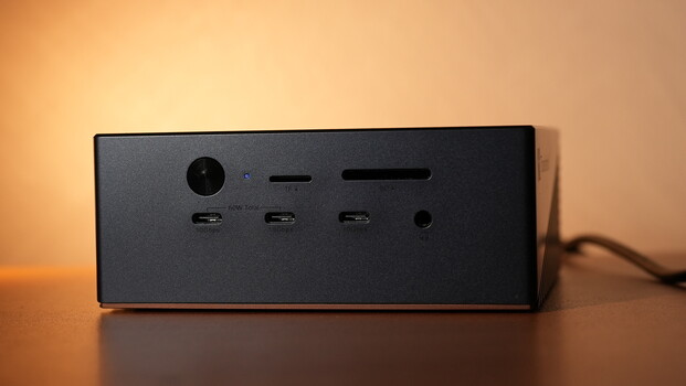 Black rectangular device with power connector, three USB-C ports, and 3.5mm audio jack on front panel.