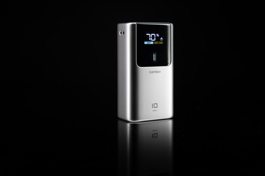 Sleek white and silver portable device with digital display showing 70°F temperature reading against black background.