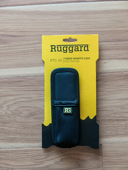 Ruggard camera case in protective retail packaging on wooden surface