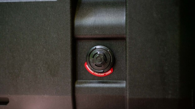 Close-up of a camera's red recording indicator light mounted on equipment
