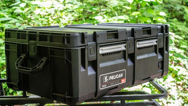 Pelican case with dual latches and handles on outdoor table with foliage background