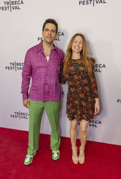 Two people posing on a red carpet at the Tribeca Festival