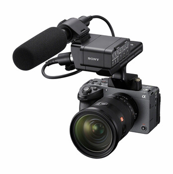 Sony mirrorless camera with attached microphone and portable recorder mounted on top