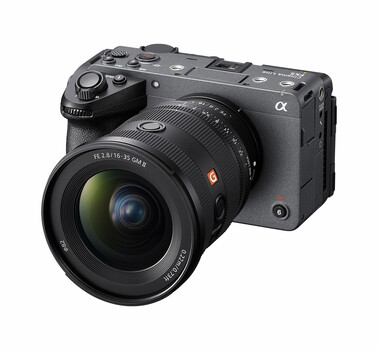 Sony α mirrorless camera with attached wide-angle zoom lens against white background