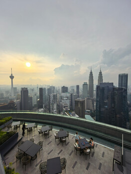 Kuala Lumpur skyline at golden hour from elevated observation deck with twin towers visible