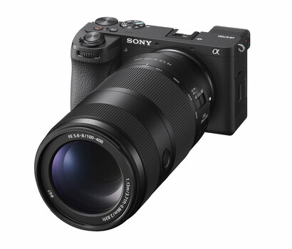 Sony α mirrorless camera with attached telephoto zoom lens against white background