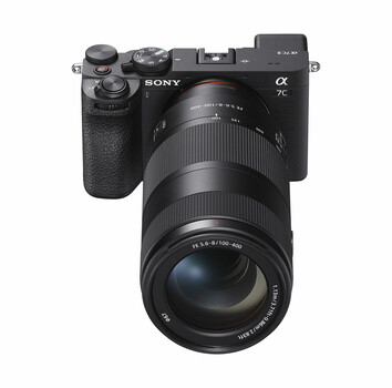 Sony α7C mirrorless camera with attached telephoto zoom lens, displayed against white background