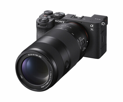 Sony α7C mirrorless camera with attached telephoto zoom lens against white background