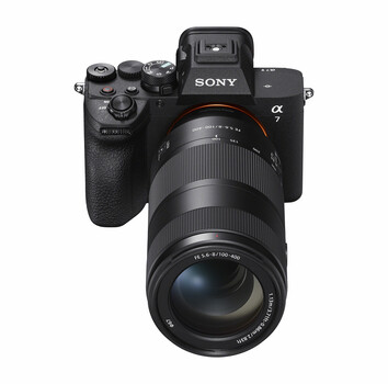 Sony α mirrorless camera with telephoto zoom lens mounted, front-facing product shot
