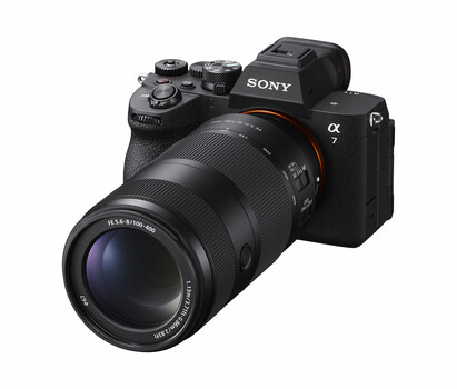 Sony Alpha mirrorless camera with attached telephoto zoom lens against white background