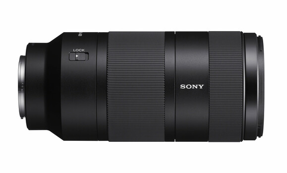 Sony telephoto zoom lens with black rubber grip and focus lock mechanism