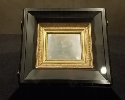 Nested ornate picture frames with gold and dark metallic finishes