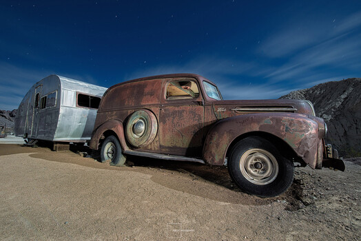 Getting down low. Rusty Ford and camper.