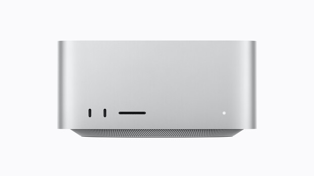 Illustration of a compact silver desktop device with minimalist front panel featuring two circular ports and a horizontal bar element