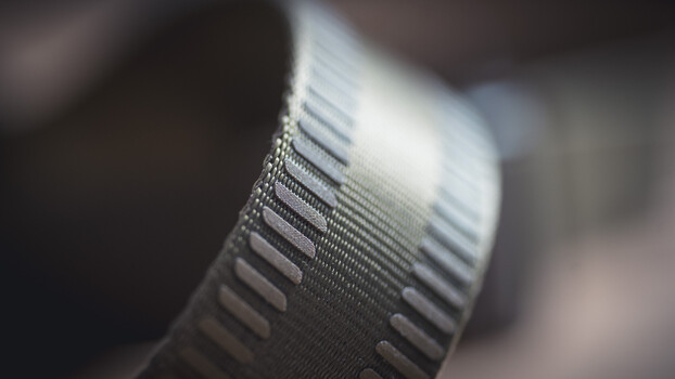 Close-up macro shot of camera lens focus ring with depth of field blur