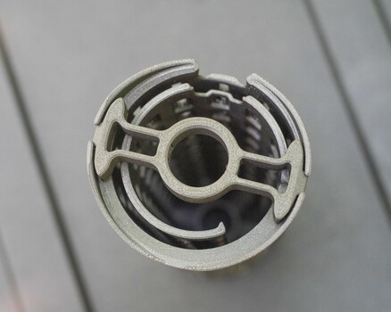 Close-up of a white plastic fan shroud or motor housing with circular vanes and central opening
