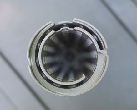 Close-up of camera lens element showing internal glass surfaces and mechanical aperture blades