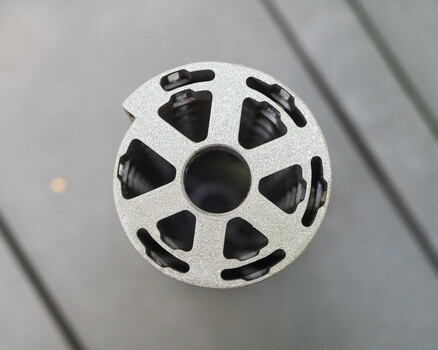 White spherical object with black triangular cutouts arranged symmetrically around its surface