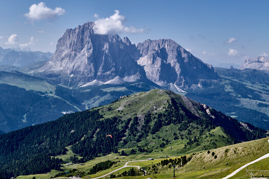 Alpine mountain landscape with dramatic limestone peak and forested valley