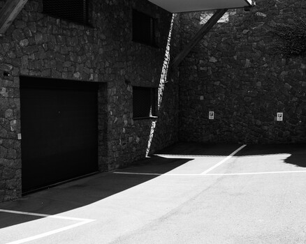 Black and white photograph of modernist stone architecture with geometric shadows