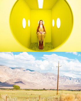 Woman seated inside a large yellow spherical sculpture against a desert landscape backdrop