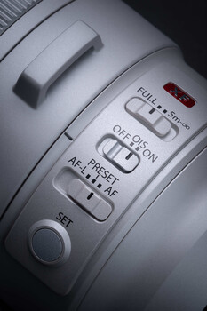 Close-up of camera lens control ring showing aperture settings from f/5.6 to f/32