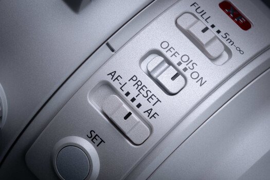 Close-up of camera autofocus control buttons showing OFF, ON, AF, and RESET options