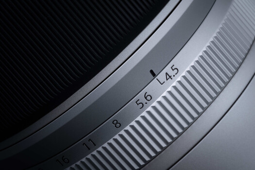 Close-up of camera lens aperture scale showing f-stop markings from 4.5 to 11