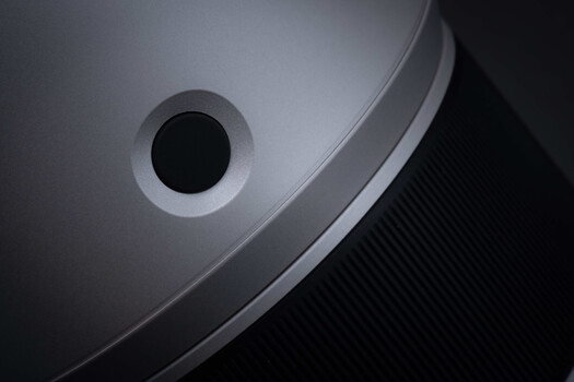 Close-up of a smartphone camera lens with metallic ring and black aperture opening