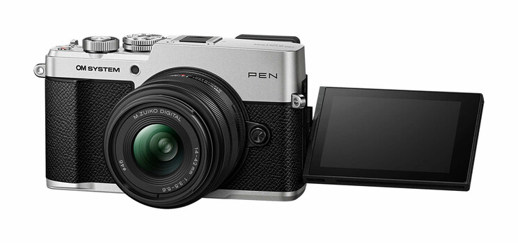 OM System Pen mirrorless camera with silver body, black grip, and articulating touchscreen display