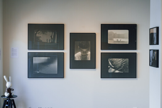 Gallery wall with six framed black and white photographs arranged in an asymmetrical layout