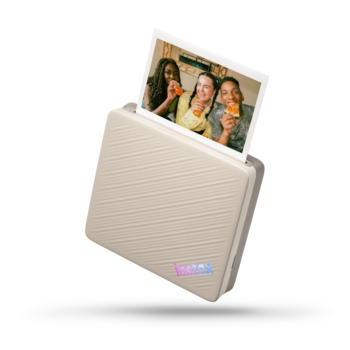 Instant photo printer with cream-colored ridged exterior dispensing a photo of people