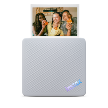 Portable photo printer with printed photo preview displayed on top surface