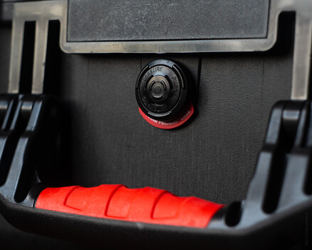 Close-up of a camera or imaging device's control dial with red accents and adjustment knob