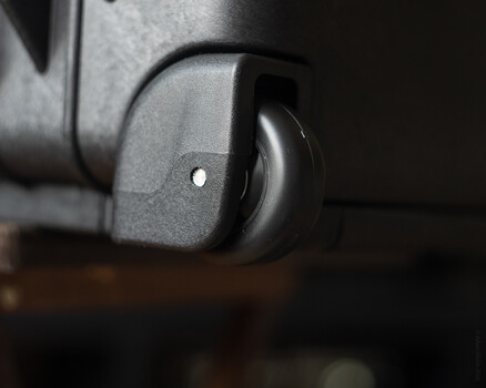 Close-up of a camera lens focusing ring with shallow depth of field against dark background