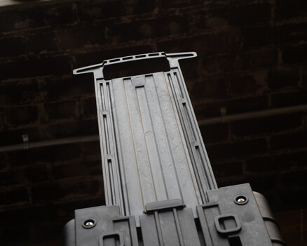 Studio strobe with reflector and chain suspension system against dark background