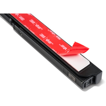 Black camera strap with red adhesive 3M label and pull tab