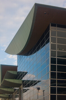 Modern glass and metal office building with angular cantilevered roof elements