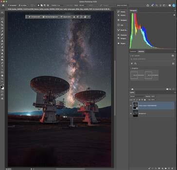 Large radio telescope dishes silhouetted against the Milky Way at night