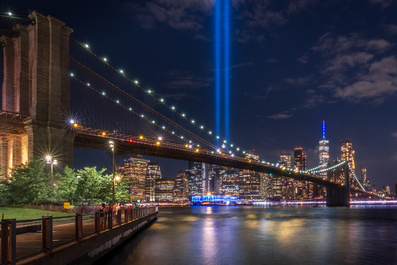 New York City Skyline with 9/11 tribute lights with Brooklyn Bridge by Alex Schmutz