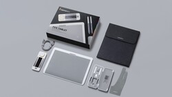 Flat lay of a pen tablet and accessories arranged on a neutral gray surface.