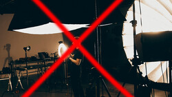 Studio setup with red X overlay across lighting equipment and workspace.