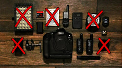 Canon DSLR camera body surrounded by marked-off photography accessories on wooden surface.