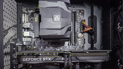 Interior view of a computer case showing motherboard, GPU, and CPU cooler installation.
